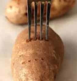 Pierce the potatoes with a fork