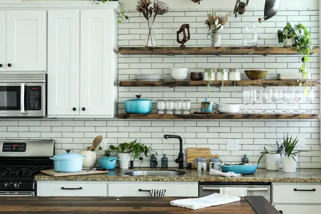 Messy kitchen with white cabinets,