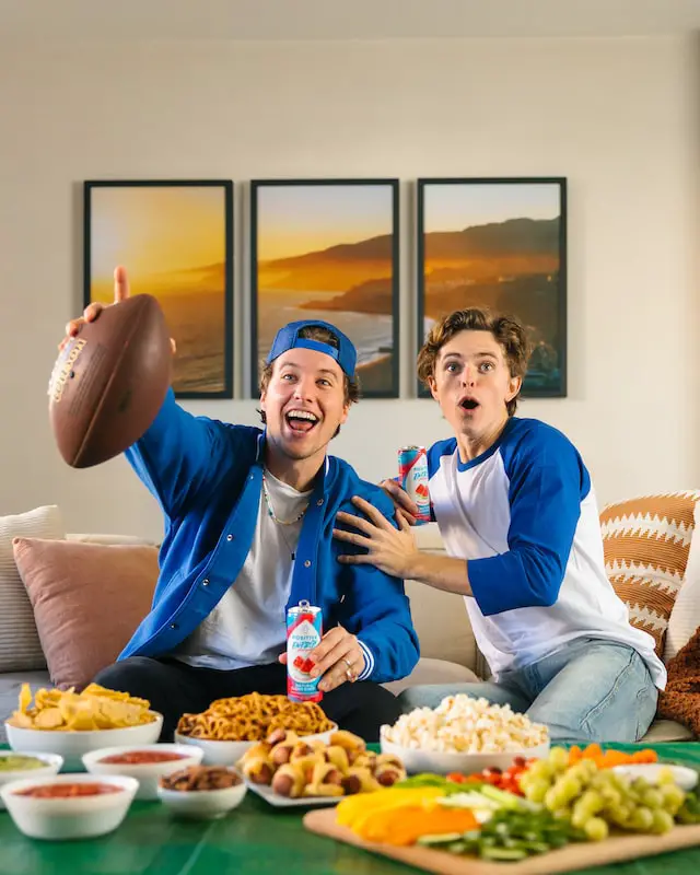 Football fans watching a game with snacks